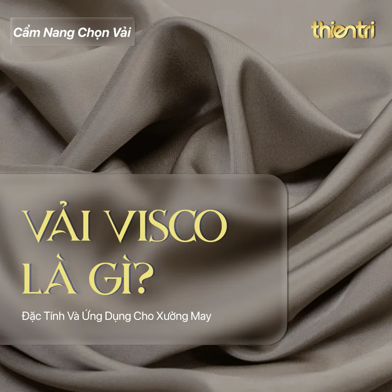Thẻ tiêu đề bài Vải Visco Là Gì, chữ vàng trên nền nền vải màu nâu xám với nếp gấp mềm, kèm logo Thiên Trì Textiles Factory